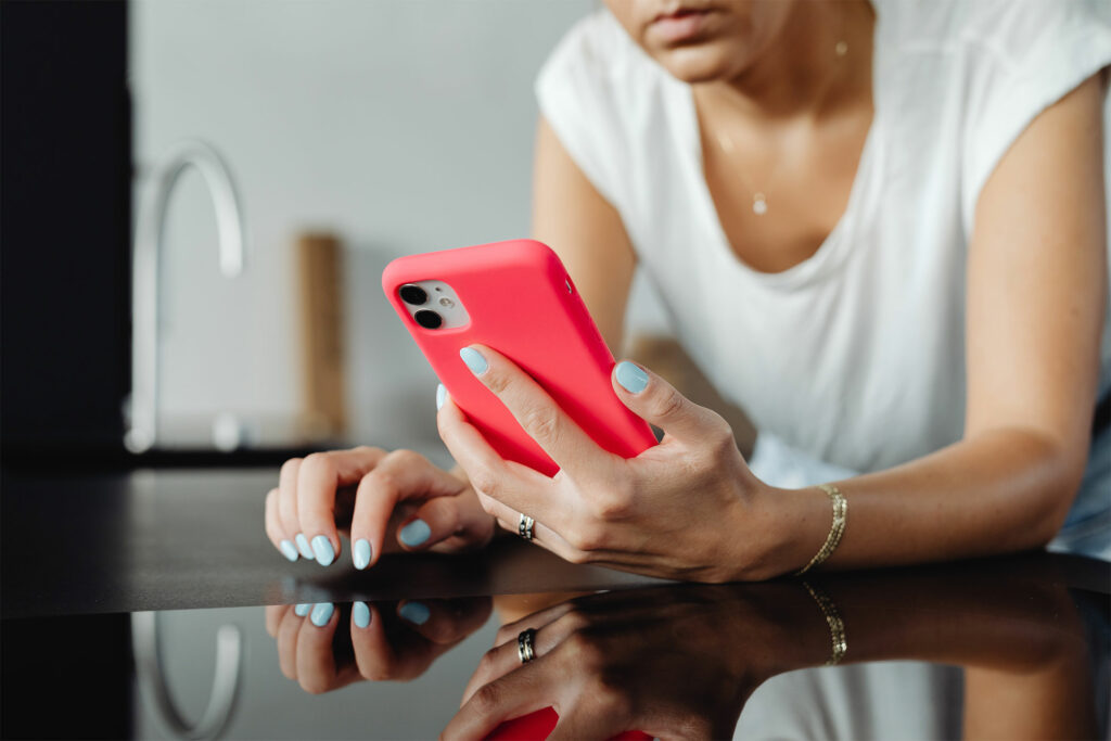 woman using Parler on her phone