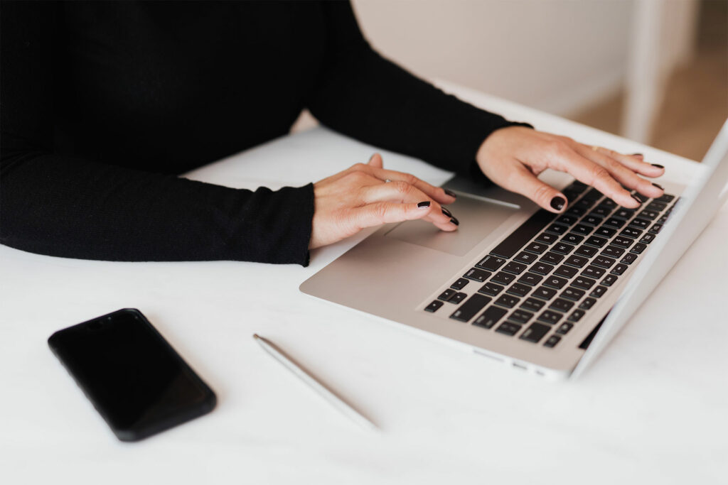 woman typing on a laptop