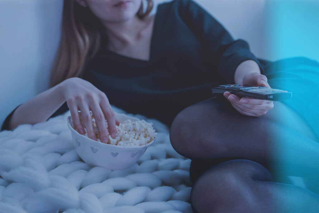 woman enjoying popcorn while watching GOtv movies