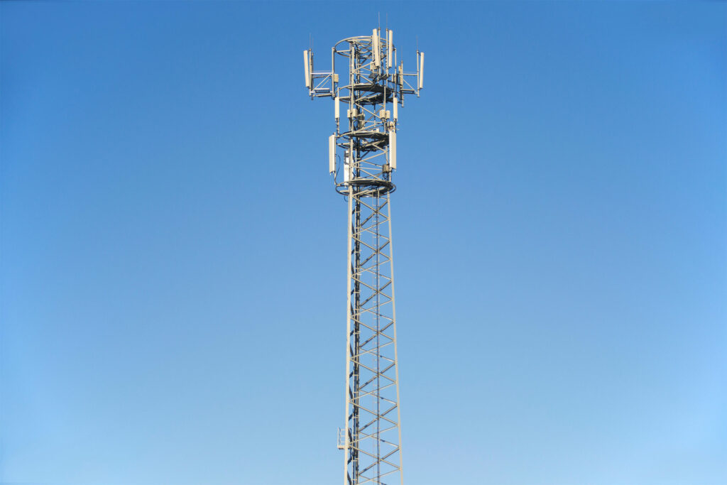 a cellphone tower under the blue sky